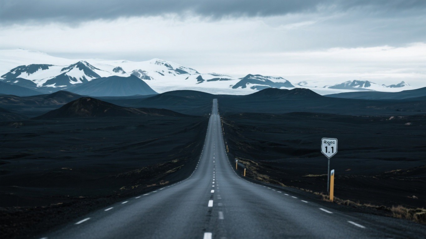 Empty Icelandic Ring Road stretching into the distance through volcanic landscape